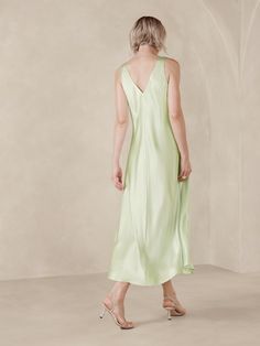 This floaty midi dress is cut with inset godet panels to increase the sweep of its skirt.  For fabric, we selected our signature silk charmeuse, a fabric we love for its beautiful drape, satin-like shine, and ease of care.  Trapeze Fit: Cut for a flowing, A-line fit.  No waist definition.  Scoop neck.  Scoop back.  Fully lined.  Trapeze Fit: Cut for a flowing, A-line fit.  No waist definition.  Sleeveless.  Midi length.  Model: Size S, 5'10" (178cm). Spring Satin A-line Midi Dress, Spring A-line Midi Dress With Bias Cut, Chic A-line Maxi Dress With Bias Cut, Flowy Silk A-line Midi Dress, Summer A-line Bias Cut Slip Dress, Feminine Bias-cut Silk Dress, Summer Satin A-line Midi Dress, Summer V-neck Modal Satin Dress, Chic Satin A-line Midi Dress