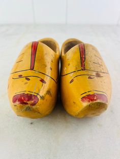 These antique wooden shoes, called clogs, were worn in Holland until the early mid century. This pair is hand made and hand painted and is in very good condition with a few signs of wear. Features hand painted red and black floral and striped details.  In excellent vintage condition. Measures: 8" (20 cm) long 3 1/4" (8.5 cm) wide 3 3/4" (9.5 cm) tall Vintage Wooden Heel Closed Toe Clogs, Vintage Clogs With Wooden Heel And Closed Toe, Vintage Closed Toe Clogs With Wooden Heel, Vintage Clogs With Rubber Sole And Round Toe, Vintage Slip-on Clogs With Rubber Sole, Clogs And Mules, Century Decor, Wooden Clogs, Wooden Shoes