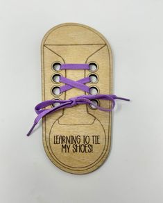 This handmade wooden shoe-shaped piece is perfect for children who are learning to tie their shoes. The intricate engraving on the wood makes it a beautiful addition to any collection, while the laser cut production technique ensures a high level of quality. Whether it's a gift for a young one or an addition to a teachers collection, this piece is sure to be used over and over again. The shoelace color is of your choice. Gift wrapping available.  Select during checkout. Teaching Shoe Tying, Tie Shoes Kids, Learn To Tie Shoes, Shoes Tie, Santa Plate, Teacher Ornaments, Wooden Shoe, Tie Shoelaces, Custom Gift Tags