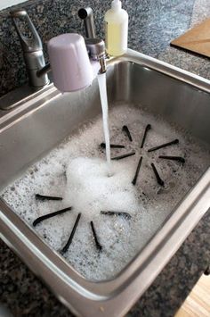 a kitchen sink filled with water and sand