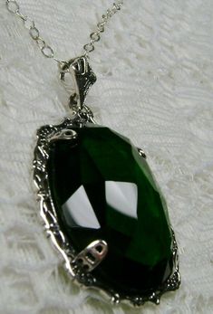 "Simulated Green Emerald Pendant Bubble Design#P10 Custom Made Inspired by Victorian era designs, I now offer this lovely Antique reproduction in sterling silver. The 22ct faceted simulated green emerald gemstone is 24mm long (15/16th\") and 18mm in width (3/4th\"). The entire pendant is 1.5\" long and 7/8\" wide. The chain (if chosen) is between 18-20 inches in length and is marked 925 as well. Notice the beautiful craftsmanship of the Victorian filigree setting. This pendant necklace is a true Green Amulet Necklace, Emerald Necklace Aesthetic, Green Necklace Aesthetic, Villain Ocs, Delilah Briarwood, Qi Rong, Dnd Oc, Victorian Filigree, Mystic Fire Topaz