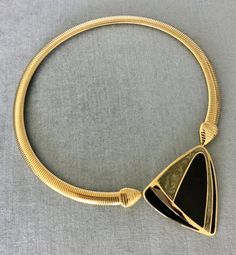 You are looking at a truly exquisite VINTAGE TRIFARI MODERNIST, ART DECO STYLE, KUNIO MATSUMOTO ERA, BLACK and SILVER-COLOURED ENAMEL AND GOLD METAL OMEGA SNAKE CHAIN PENDANT COLLAR NECKLACE, SIGNED, Circa 1980's.THIS COLLAR NECKLACE IS EXTREMELY BOLD, EYE-CATCHING AND GORGEOUS!!!SUPER RARE!!! MINT, IN EXCELLENT, LIKE NEW CONDITION, IT HAS NEVER BEEN USED!!!THIS NECKLACE WITH AN ART DECO INSPIRED BLACK AND SILVER ENAMEL STATION AND SUPER SHINY OMEGA CHAIN IS EXTRAORDINARILY BEAUTIFUL AND SCULPTU Vintage Jewelry With Unique Design For Formal Occasions, Vintage Formal Jewelry With Unique Design, Unique Metal Necklaces For Formal Occasions, Gold Necklace With Black Enamel For Formal Occasions, Elegant Evening Necklaces With Black Enamel, Formal Gold Necklace With Unique Design, Elegant Black Enamel Necklaces For Evening, Elegant Evening Necklace With Black Enamel, Elegant Evening Black Enamel Necklaces