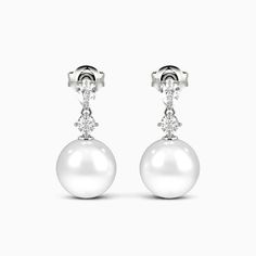 A stunning showcase of elegance and refinement, these drop earrings delight at first glimpse. Each earring features a lustrous pearl suspended with soft grace beneath a pear and round gemstone. The elegant design sways gently with your movements, gleaming subtly to draw admiring eyes. Whether worn for day or evening, the understated luxury of these drops enhances any outfit with impeccable taste and sophistication. *Each piece is handmade, resulting in a potential variance of 0.1-0.2mm during me Elegant Earrings With Timeless Design, Elegant Timeless Earrings For Anniversary, Luxury White Pear-shaped Pearl Earrings, Timeless Pear-shaped Earrings For Formal Occasions, Timeless Pear-shaped Formal Earrings, Luxury Drop Pearl Earrings For Formal Occasions, Luxury Drop Pearl Earrings For Formal Events, Classic Diamond Teardrop Pearl Earrings, Classic Teardrop Diamond Pearl Earrings