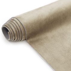 a roll of tan colored paper on top of a white surface with grey lines in the middle