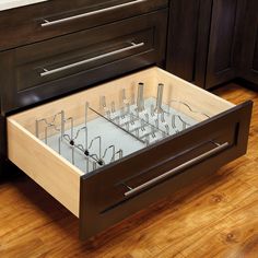 an open drawer in the middle of a kitchen