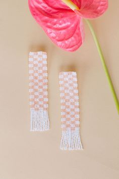 This Mary is all about how her garden grows. Our hand beaded checker print statement earrings with fringe detail on the bottom are perfect to be paired with our Evan hat, or a basic white t-shirt. available in peach plaid: our opaque peach with bright white - glass bead plaid statement earrings - made in Mexico - stainless steel post back - 4” length 1” width .75” tassels White Handwoven Earrings For Summer, Trendy Beige Jewelry For Spring, White Fringe Earrings For Summer, Trendy Spring Jewelry With Fringe, Trendy Fringe Earrings For Summer, Checker Print, Steel Post, Hand Beading, White T Shirt