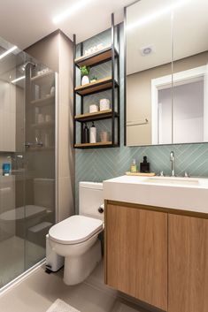 a bathroom with a toilet, sink and shower