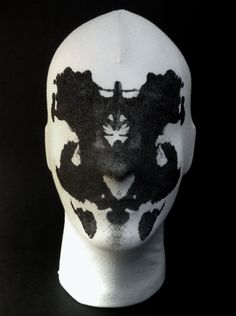 a white mask with black paint on it