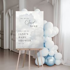 a welcome sign and balloons in front of a white backdrop with the words cloud nine on it