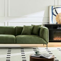 a green couch sitting on top of a white rug