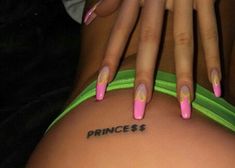 a woman with pink and green nail polish on her body is holding onto the back of her leg