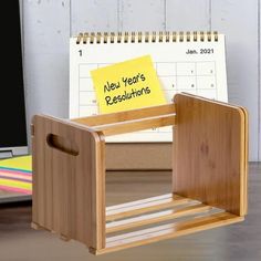 a wooden desk with a note attached to it