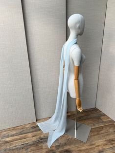 a mannequin wearing a light blue scarf