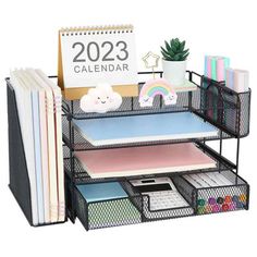 the desk organizer is organized and ready for someone to use it as a calendar holder