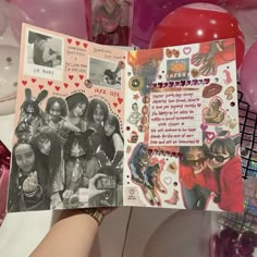 someone holding up a scrapbook with pictures and balloons in the background, as if it were for valentine's day