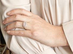 a close up of a person wearing a ring on their left hand and her right hand in the other