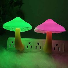 two mushroom shaped lights sitting on top of a power strip