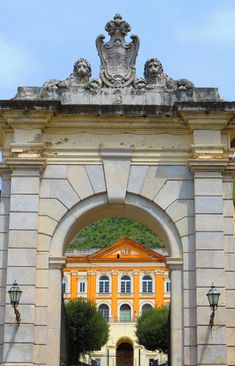 an archway leading to a yellow building