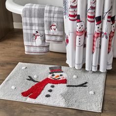 a bathroom rug with a snowman on it