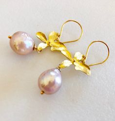 "Champagne pink Chinese freshwater Kasumi pearl earrings wire wrapped on handmade gold vermeil blossoms with 24k Gold vermeil French hooks. Beautiful 11/12mm Chinese Kasumi pearls with characteristic iridescent bumpy surface are full of color and texture and highly lustrous. Stunning Kasumi pearls are wire wrapped on artisan 22k gold vermeil blossom. Precious metal blossom elements are made of 22k gold over solid Sterling silver. Handmade and hand brushed one at a time they measure 18 x 16mm Ear Handmade Delicate Yellow Gold Pearl Earrings, Delicate Handmade Yellow Gold Pearl Earrings, Wire Wrapped Yellow Gold Pearl Earrings Gift, Yellow Gold Wire Wrapped Pearl Earrings Gift, Handmade Gold Pearl Earrings In Flower Shape, Gold Wire Wrapped Pearl Earrings For Gift, Delicate Handmade Gold Pearl Earrings, Elegant Pink Pearl Earrings For Celebration, Handmade Gold Pearl Earrings For Celebration