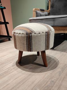 a foot stool sitting on top of a hard wood floor