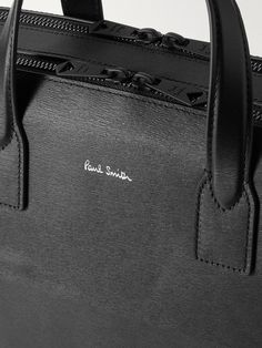 A sleek briefcase will never go out of style. This Paul Smith one is made from textured-leather and has an adjustable, logo-embossed strap you can sling over your shoulder. It features two sizeable compartments and the label's signature 'Artist Stripe' through the satin-lined interior. Timeless Saffiano Leather Shoulder Bag For Business, Business Shoulder Bag With Adjustable Strap In Saffiano Leather, Luxury Textured Leather Satchel For Business Trips, Designer Briefcase With Adjustable Strap, Classic Leather Shoulder Bag With Embossed Logo, Classic Black Shoulder Bag With Engraved Logo, Luxury Textured Leather Briefcase For Business Trips, Designer Briefcase With Detachable Strap, Designer Office Briefcase With Adjustable Strap