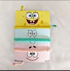 five spongebob hair ties are stacked on top of each other in different colors