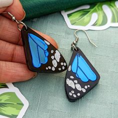 Butterfly Wing earrings, feature a single wing for each ear in either blue or pink. They are made with shiny acrylics and engraved with details. A cute accessory for any aesthetic. Get them with ear hooks as pictured or select ball post studs, huggies/leverbacks, or clip-ons. If you would like gold-toned metal, add it to the special instructions in your cart!Dimensions:1.5 in (38mm) L X 0.95 in (24mm) W2.0 in (51mm) drop Materials: Acrylic Hypoallergenic Stainless Steel Note: Mirror acrylic has Blue Plastic Earrings For Gift, Blue Plastic Jewelry As A Gift, Blue Resin Teardrop Earrings, Blue Hypoallergenic Resin Earrings, Butterfly Wing Earrings, Blue Or Pink, Mirror Acrylic, Earring Organizer, Butterfly Wing