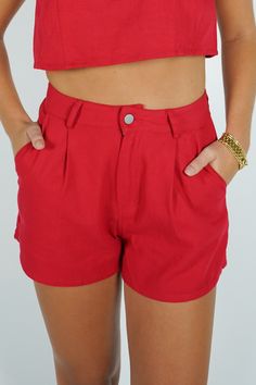 Get ready to stand out with these Leslie Shorts! These pleated red shorts will add a playful pop of color to any outfit. With their unique design, you'll be sure to turn heads and make a statement. Perfect for those who like to have a little fun with their fashion! Size + Fit Patton is 5'9" and wearing a size Small Content + Care 100% Cotton Hand Wash Cold Color Separate Red Summer Shorts With Elastic Waistband, Red Elastic Waistband Shorts For Summer, Red Bottoms For Day Out, Red Cotton Shorts For Day Out, Trendy Red Bottoms For Summer, Chic Red Shorts For Spring, Trendy Red Summer Shorts, Chic Red Spring Shorts, Trendy Red Summer Bottoms