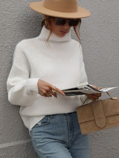 Our Chester Knit is a beautiful cotton white tone with turtleneck that is most definitely an essential this A/W. The wool blend fabric is perfect for keeping you cosy during the cooler months, whilst the statement cuff on the sleeve and the knit speckled detailing throughout the fabric create a perfect, go-to classic staple. Pair it with your favourite ankle boots or ugg as a comfy A/W go-to look! Size Guide: Ambre is 5’2” tall, and has a 33.2” bust, 24.5”waist, & 36.7” hips. She is wearing a S White Oversized Turtleneck Outfit, Highnecksweater Outfits Women, White Pullover Outfit Winter, White Turtleneck Outfit Women, How To Style A White Turtleneck, White Turtleneck Outfit Winter, White Pullover Outfit, White Turtleneck Sweater Outfit, Astronaut Oc