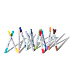 four different colored pens lined up in the shape of x