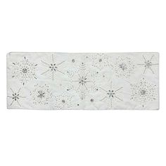 a white table runner with snowflakes on it