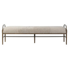 a bench that is made out of metal and sheepskin