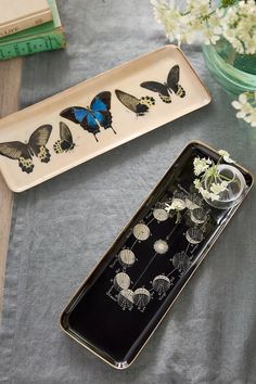 two trays with flowers and butterflies on them