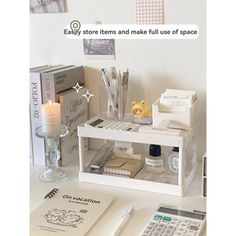 a white desk topped with books and a calculator