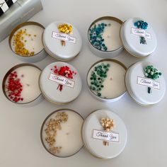 six small plates with different types of candies in them