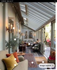 a living room filled with furniture and lots of windows