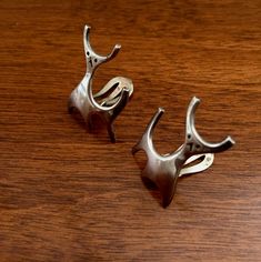 "This listing features a Vintage pair of highly collectible Sterling Silver Rasmussen Lassen DEER Clip on Earrings. The earrings beautifully capture the modernist design of Rasmussen Lassen. The earrings are very modern looking, as fashionable today as when they were created, which I believe dates to the 1960s. The earrings have clip on back closures that work properly. The earrings are in excellent condition for their age and show little to no wear to the silver. The earrings have a lovely soft Sterling Silver Clip-on Earrings For Formal Occasions, Classic Adjustable Earrings For Formal Occasions, Modern Formal Clip-on Hallmarked Earrings, Artistic Adjustable Formal Jewelry, Unique Metal Earrings For Formal Occasions, Formal Metal Earrings With Polished Finish, Elegant Metal Earrings, Formal Polished Metal Earrings, Modern Hallmarked Clip-on Earrings For Formal Occasions