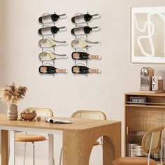 a dining room table and chairs with wine racks on the wall