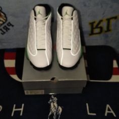 Air Jordan Retro 13 White Lucky Green Black Great Outfit Piece White High-top Sporty Golf Shoes, Sporty High-top White Golf Shoes, White Jordan Sports Shoes With Perforations, White Jordan Shoes With Perforations For Sports, White Low-top Golf Shoes With Perforations, White Perforated Lace-up Golf Shoes, White Lace-up Golf Shoes With Perforations, White Jordan Casual Shoes With Air Cushioning, Casual White Jordan Shoes With Air Max Cushioning