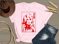 Dolly Parton Queen of Heart t-shirt. Sizes S-3X. Brands and color shades of the shirts vary.   Automatically comes on a pink crew neck. Please feel free to reach out for other styles, colors or sizes. Shirts are generally a cotton-feel polyester shirt which are used for sublimation printing. Pink Short Sleeve T-shirt With Heart Graphic, Pink Short Sleeve Shirt With Heart Graphic, Queen Of Heart, Pink Crew Neck, Heart T Shirt, Pink Crewneck, Pink T Shirt, Dolly Parton, Pink Tshirt