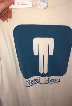 someone is holding up a t - shirt that says need head