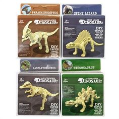 four dinosaur toys are shown in the package