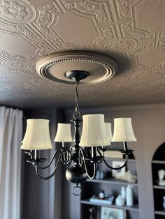 a chandelier hanging from the ceiling in a living room