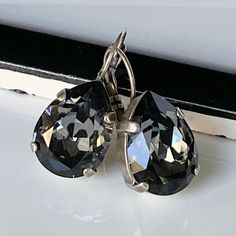 "These gorgeous earrings display dazzling crystal silver shade teardrops. The Swarovski crystals are set in sterling silver-plated bezels and hang from silver lever back earrings.  Perfect for that special occasion! * Swarovski Crystal Teardrops- 1/2x3/4\"(13x18mm) * Antique Silver-Plated Bezels and Earrings * Length- 1 1/4\"(31mm) * Nickel Free These earrings come in a jewelry bag and gift box." Silver Drop Crystal Earrings For Formal Occasions, Formal Silver Hypoallergenic Crystal Earrings, Silver Pear-shaped Sterling Silver Crystal Earrings, Silver Hypoallergenic Crystal Earrings For Formal Occasions, Silver Sterling Silver Pear-shaped Crystal Earrings, Pear-shaped Sterling Silver Crystal Earrings, Silver Crystal Long Drop Teardrop Earrings, Silver Teardrop Crystal Earrings, Sterling Silver Teardrop Earrings With Sparkling Stones