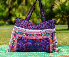 "Large Embroidered Bag, Vibrant Tote Bag, Hippie Tote Bag This beautiful multi colored shoulder tote hand bag is made from embroidered Hmong fabric in stunning colors. The Hmong are a hill tribe people who live in the north of Thailand - also known as the Lanna region. The bag has a zipper closure at the top and is tapered from the top to the bottom - which adds a nice shape to the bag. Inside the bag is lined with a black strong cotton fabric. The is a zipper pocket on the inside for keys, coin Hippie Tote Bag, Hmong Fabric, Boho Tote Bag, Ethnic Bag, Boho Tote, Bag Inside, Yoga Bag, Embroidered Bag, Shoulder Tote