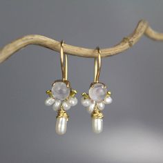 These handcrafted dancer earrings are petite, delicate and whimsical. The unique copper bezel setting showcases a gorgeous cabochon moonstone. Beautiful and feminine pearls are hand woven and a lovely pearl dangles gently. Measurements: Center stone: 5mm Total length including hook: 2.5cm Drop length (without hook): 1.5cm Materials: Stone: moonstone, pearl Bezel: copper Hook: gold filled These romantic dancer earrings seem to come straight from a fairytale! They're the perfect pair of earrings t Delicate Moonstone Earrings For Wedding, Delicate White Moonstone Earrings, Delicate Moonstone Wedding Earrings, Hand Forged Wedding Earrings, Handmade Moonstone Earrings For Wedding, Handmade Moonstone Wedding Earrings, Hand Forged Drop Earrings For Wedding, Hand Forged Dangle Pearl Earrings For Gifts, Handmade Dainty Moonstone Earrings