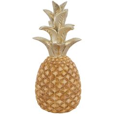 a gold pineapple shaped vase sitting on top of a table