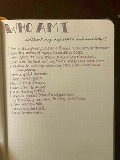 an open notebook with writing on it that reads who am i? and someone is holding a teddy bear