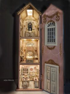 an elaborate dollhouse is shown with its doors open